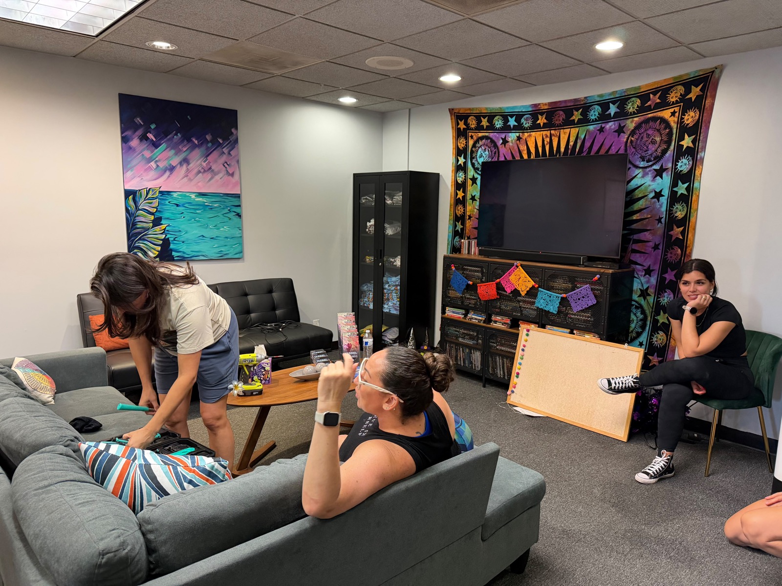 Volunteers setting up furniture in the lounge