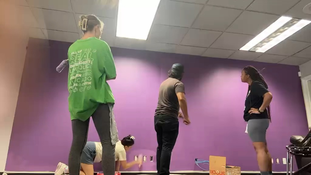 Volunteers painting a wall
